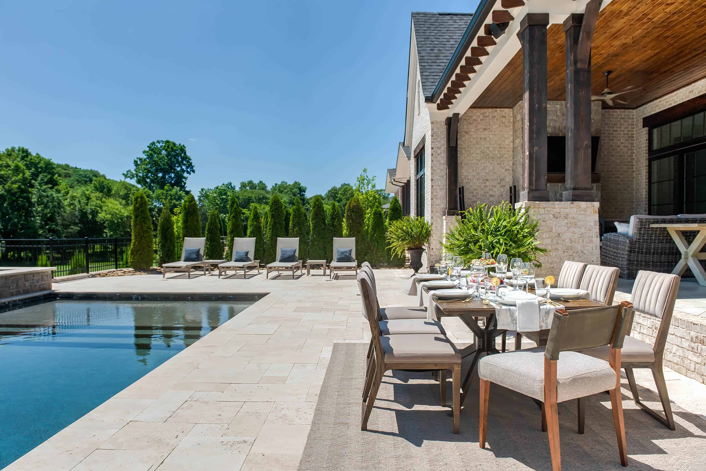 Dining table next to a swimming pool